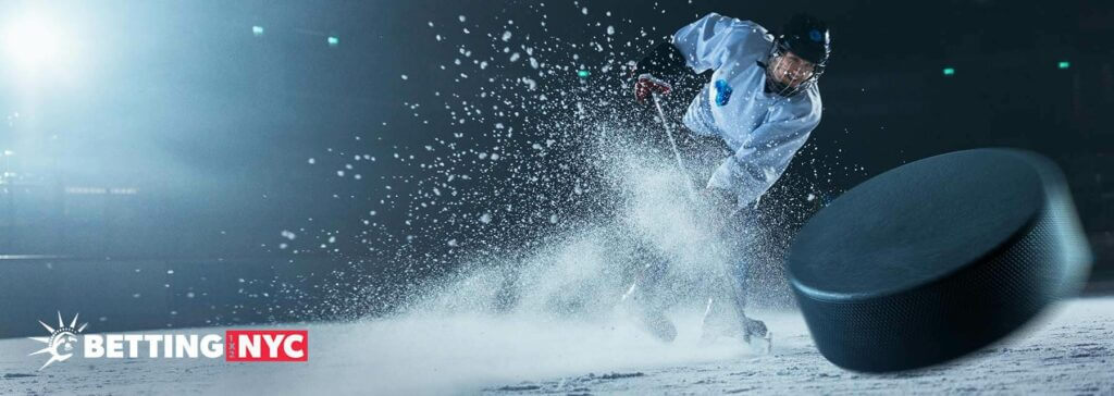 boy shooting a puck at the camera in a cloud of snow and ice